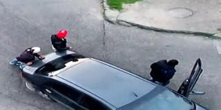 Tres hombres cometiendo un presunto hurto de un vehículo de plataforma.