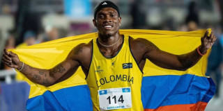 Foto que muestra al deportista Ronal Longa Mosquera con una bandera de Colombia