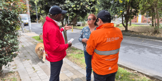 Foto que muestra tres personas hablando 