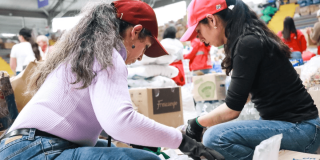 Mujeres voluntarias empacando cajas en una vivienda en Bogotá.