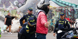 Foto de uniformados de la Policía, realizando requisas en calle de Bogotá.
