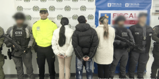 Tres capturados, en medio de policías y funcionarios de la Fiscalía.