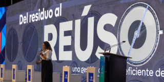 Foto que muestra una mujer hablando por un micrófono 