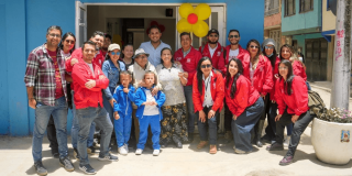 Foto que muestra un grupo de personas reunidas y sonrientes 