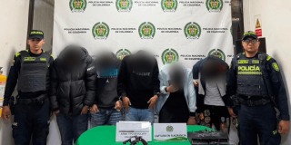 Foto de cinco capturados en medio de dos policías.