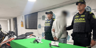 Hombre capturado en medio de dos policías.
