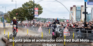 Imagen de muchas personas mirando una competición de motos en una calle de Bogotá adecuada para este espectáculo.