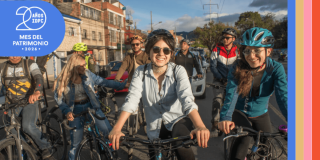 Imagen de personas en bicicleta con logos del mes del patrimonio 2026