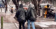 Foto que muestra personas caminando bajo la lluvia 
