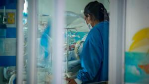 Doctora junto a una incubadora 