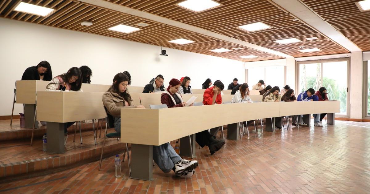 Foto que muestra estudiantes sentados en un salón 
