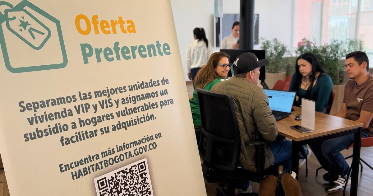 Foto que muestra un grupo de personas hablando sentadas en un escritorio