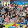 Imagen de niños, niñas y voluntarios posando para la foto en la Ludoteca.