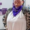 Mujer con una pañoleta morada.