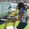Foto que muestra una persona cargando una silla y un ecopunto