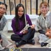 Mujeres jóvenes durante actividad artística, junto a funcionaria de la SDMujer