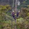 Foto que muestra dos personas con el uniforme de Enel Colombia en un poste de energía