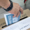 Una persona depositando su voto en un puesto de votación en Bogotá.