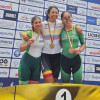 Atletas del Equipo Bogotá celebran en podio con medallas frente a panel del Campeonato Nacional de Paracycling Pista y Ruta