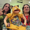 Dos hombres con un títere de un tigrillo.