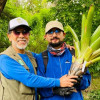Dos personas sostienen bromelia durante jornada de siembra de bromelias del Jardín Botánico en bosque urbano Brazo Salitre