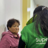 Mujer siendo atendida por una funcionaria de la Superintendencia de Salud.