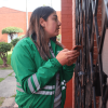 Funcionaria de la Secretaría Distrital de Ambiente realiza visita puerta a puerta en conjunto residencial del barrio Venecia para recopilar información de la comunidad durante jornada de atención ambiental.