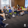 Foto que muestra un grupo de personas reunidas en un salón 