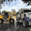 Foto que muestra un tractor recolector de residuos junto a una volqueta 
