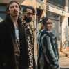 Imagen de 2 hombres y una mujer con abrigos con fondo de calle con graffitis 